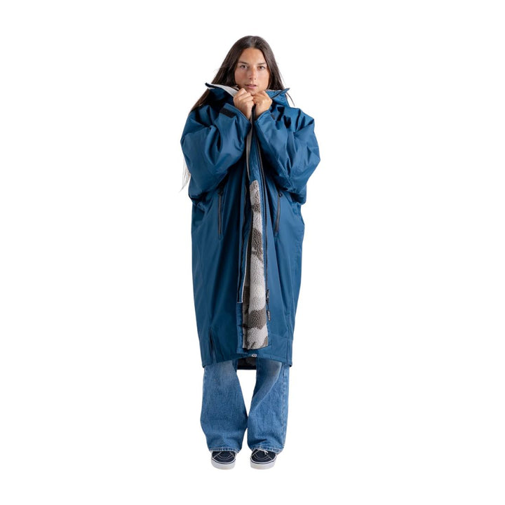 Person wearing a blue raincoat with a hood on a white background
