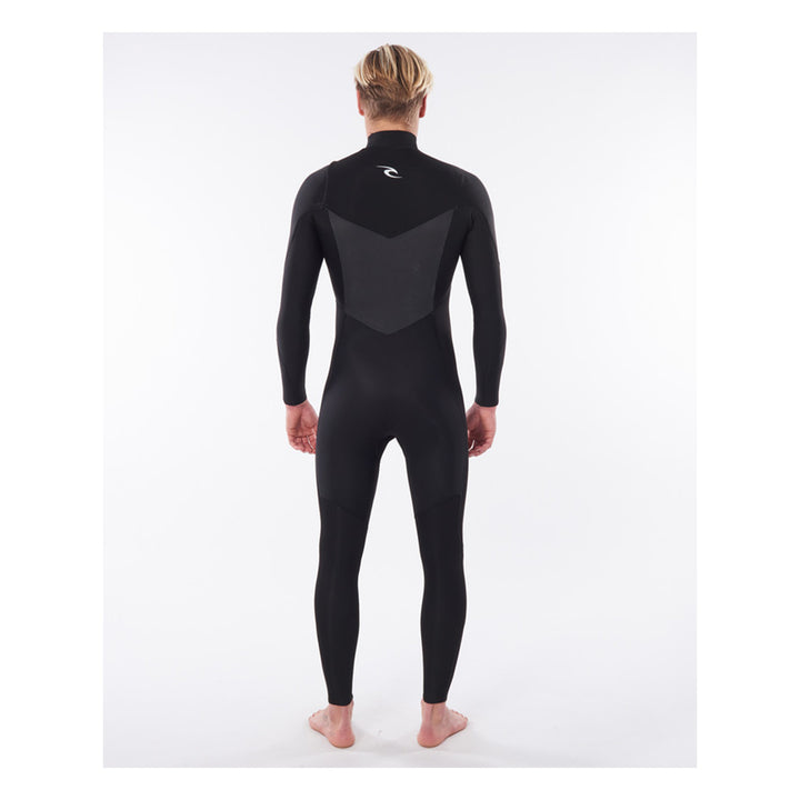 A male model wearing a black mens dawn patrol 5/3mm chest zip wetsuit with the brand name 'Rip Curl' on the chest. View of the back.
