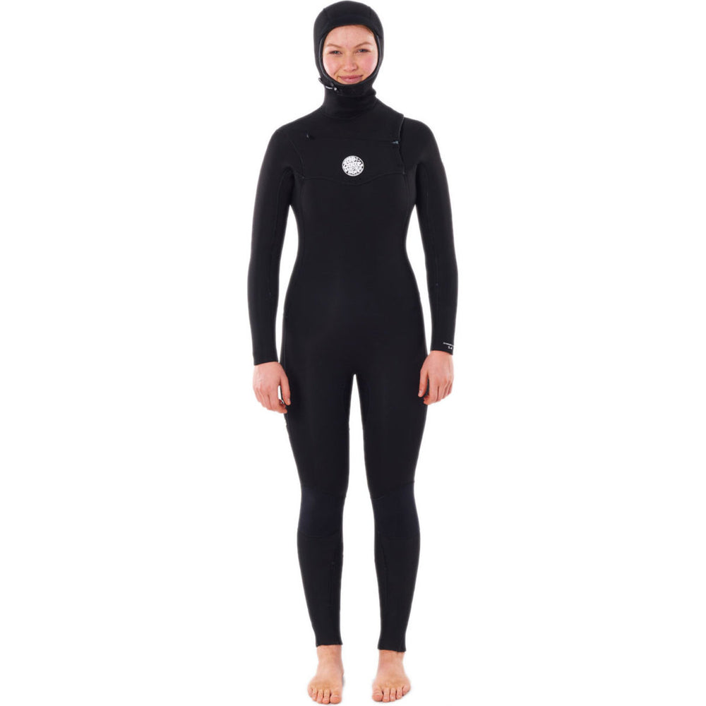 A woman wearing a Rip Curl black hooded chest zip wetsuit, designed for water sports. Front view.