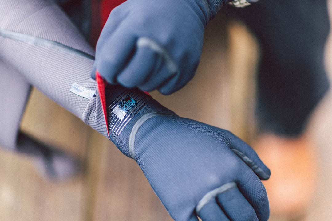 Person putting on neoprene gloves