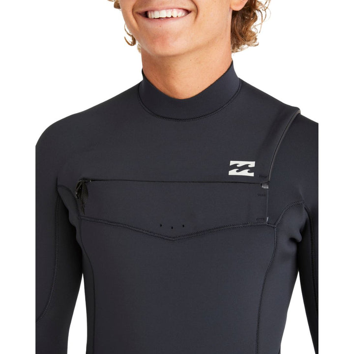 Close-up of a man wearing a Billabong Absolute Natural black mens wetsuit with a chest zip entry.