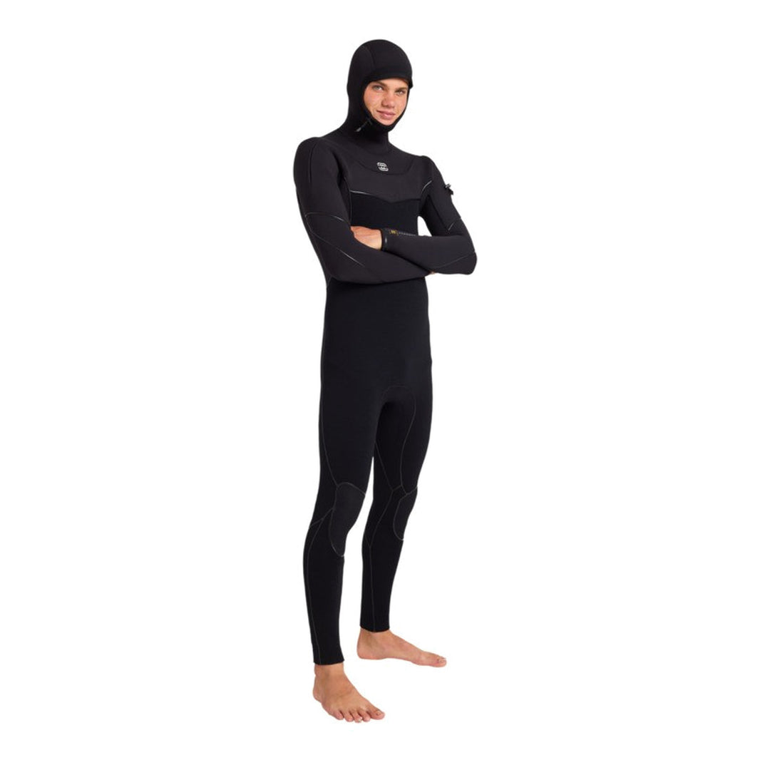 Surfer in the Billabong Furnace Ultra hooded wetsuit with arms crossed