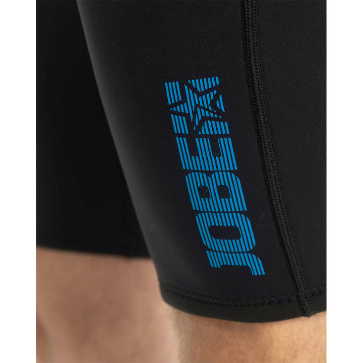 Male model wearing Jobe Perth 3mm Mens Shorty Wetsuit with a back zip entry. Close up view of the leg with Jobe logo
