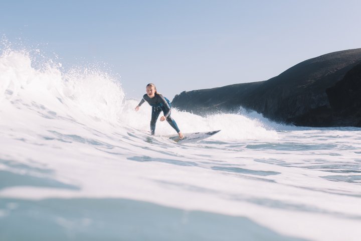A surfer wearing a full-body O'Neill kids wetsuit out surfing 