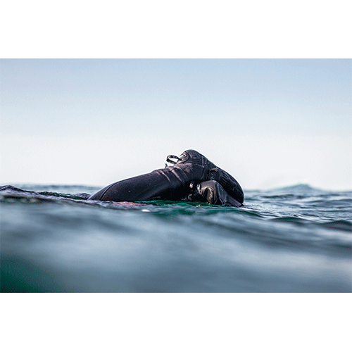 Photo of surfer wearing O'Neill 5mm Psycho Tech Round Toe boot in the water